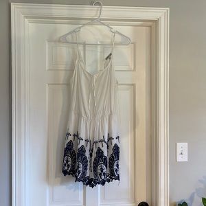 White romper with navy blue lace detail